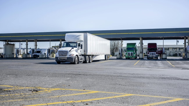 Semi trucks at gas station during the day