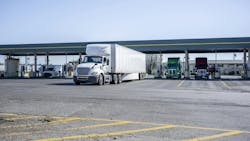 Semi trucks at gas station during the day Semi trucks at gas station during the day