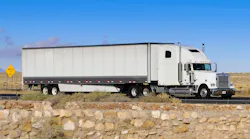 Semi truck traveling over flat, rocky road Semi truck traveling over flat, rocky road