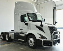 White Volvo VNL 300 day cab truck with grille guard parked indoors, showcasing modern design and front-end protection for commercial trucking fleets. White Volvo VNL 300 day cab truck with grille guard parked indoors, showcasing modern design and front-end protection for commercial trucking fleets.