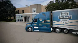 Albert Transport Freightliner Team Run Smart truck parked outside Detroit Diesel building, showcasing fuel-efficient fleet operations.