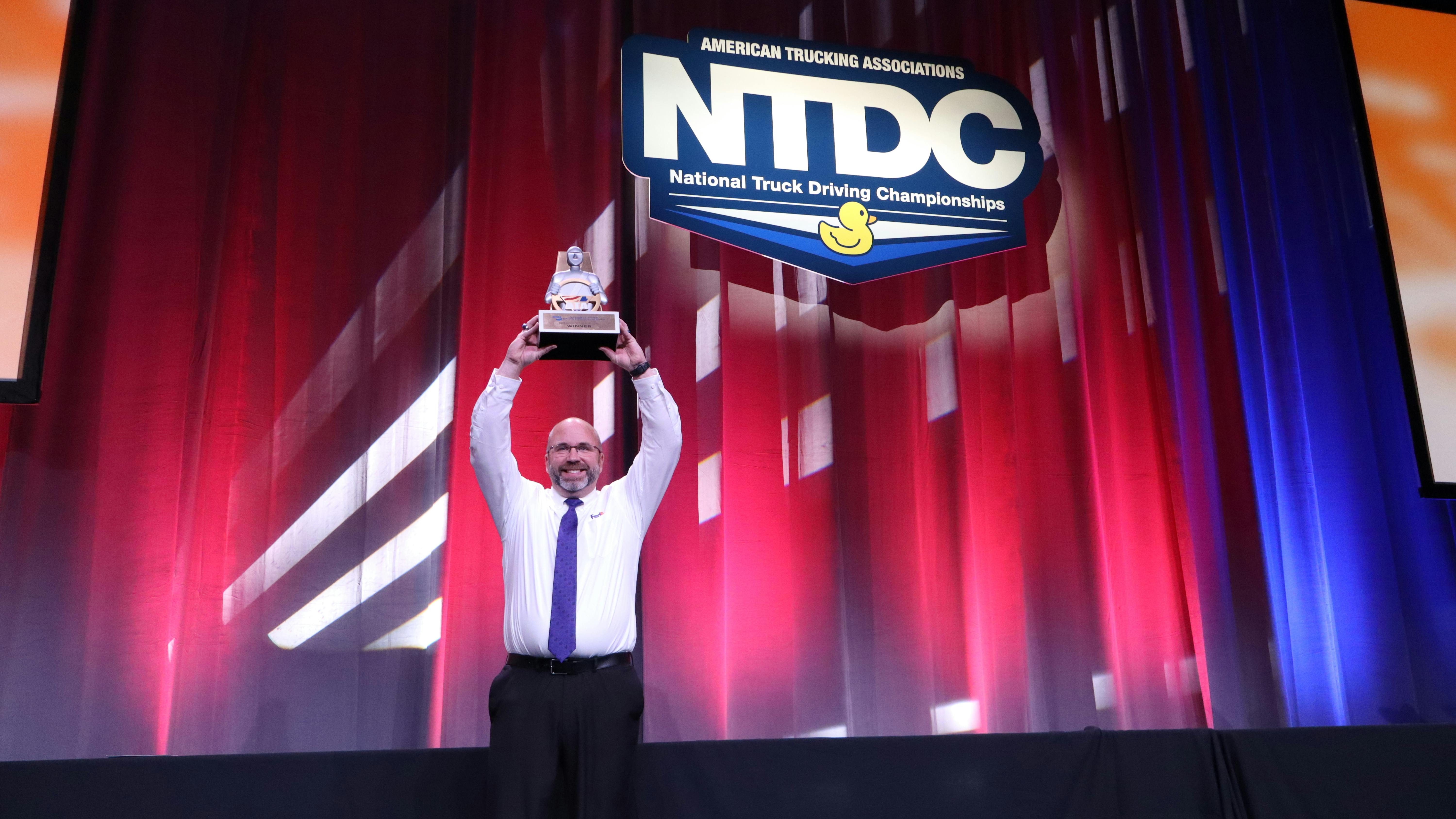 David Comings, FedEx Freight driver from North Dakota, holds the Bendix Grand Champion trophy at the 2025 National Truck Driving & Step Van Championships in Minneapolis.