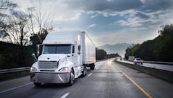 White semi-truck driving on a highway at night, hauling freight with motion blur capturing its speed. White semi-truck driving on a highway at night, hauling freight with motion blur capturing its speed.