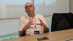 Joost de Vries, CEO of ZM Trucks, speaking during an interview at a conference table, discussing the future of the trucking and commercial vehicle industry. Joost de Vries, CEO of ZM Trucks, speaking during an interview at a conference table, discussing the future of the trucking and commercial vehicle industry.