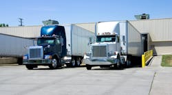 Semi-trailer trucks loading and unloading at a warehouse dock, illustrating freight shipping, logistics, and fleet operations Semi-trailer trucks loading and unloading at a warehouse dock, illustrating freight shipping, logistics, and fleet operations