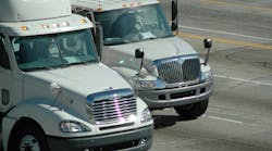 Delivery trucks traveling on a freeway in Southern California, approaching Los Angeles, illustrating regional freight transportation and logistics operations Delivery trucks traveling on a freeway in Southern California, approaching Los Angeles, illustrating regional freight transportation and logistics operations