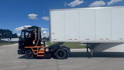 Orange EV e-TRIEVER electric terminal truck in operation at a distribution center, showcasing zero-emission yard operations Orange EV e-TRIEVER electric terminal truck in operation at a distribution center, showcasing zero-emission yard operations