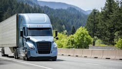 A blue Bonnet semi-truck with a black grille transports cargo in a refrigerated trailer along a highway, illustrating temperature-controlled freight logistics. A blue Bonnet semi-truck with a black grille transports cargo in a refrigerated trailer along a highway, illustrating temperature-controlled freight logistics.