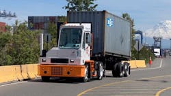 Orange EV HUSK-e electric terminal truck at a logistics facility, featuring a heavy-duty chassis and electric powertrain for efficient, zero-emission yard operations. Orange EV HUSK-e electric terminal truck at a logistics facility, featuring a heavy-duty chassis and electric powertrain for efficient, zero-emission yard operations.