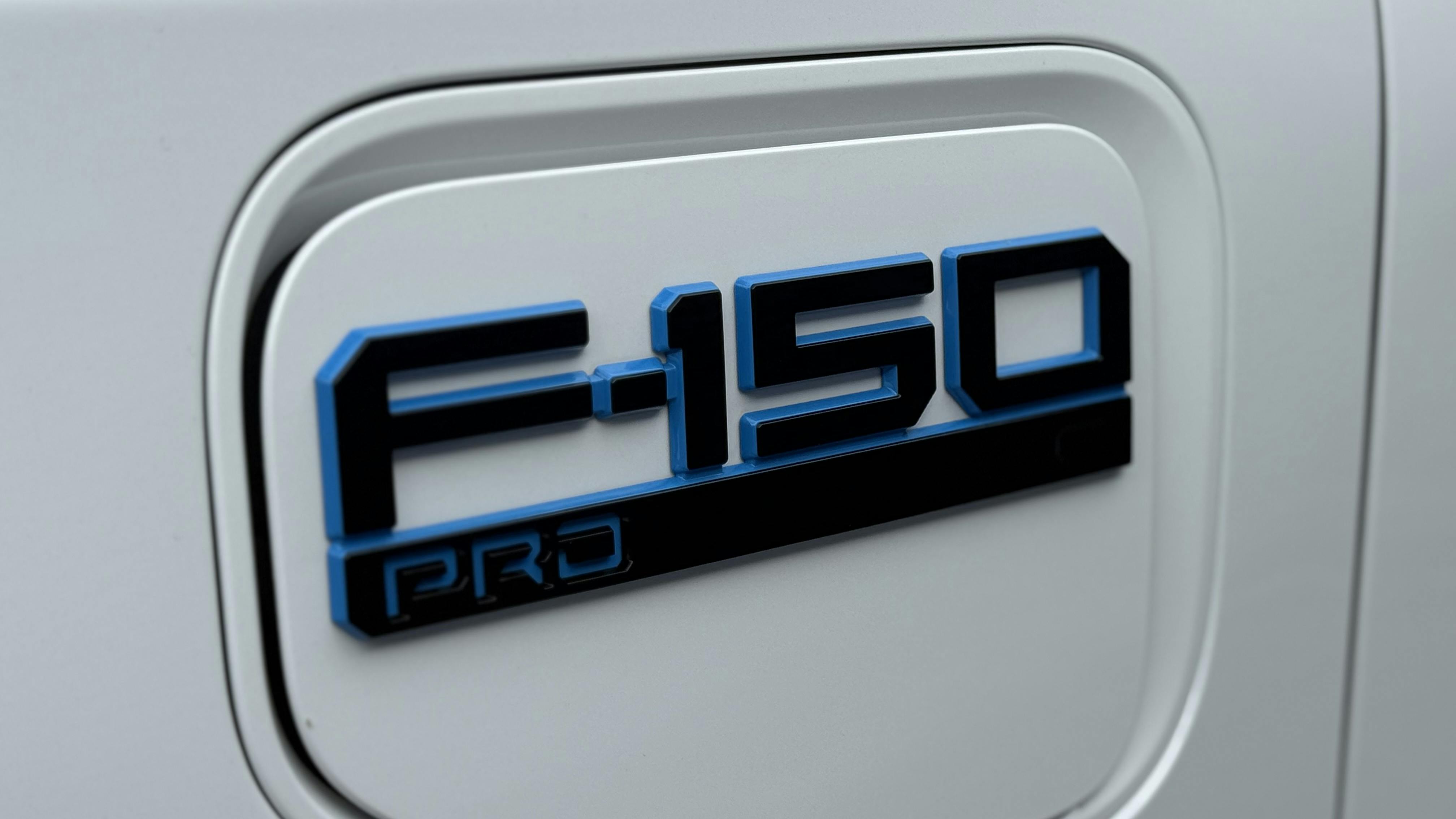 Logo for the Ford Lightning Pro on a white vehicle.