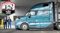 Service advisor posing with driver at truck Service advisor posing with driver at truck