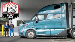 Service advisor posing with driver at truck