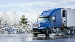 blue tractor with refrigerated trailer in winter blue tractor with refrigerated trailer in winter