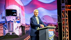 FMCSA Administrator Derek Barrs speaking passionately at a podium with the TCA logo during the Truckload 2026 convention, with a large screen displaying a semi-truck and American flag behind him. FMCSA Administrator Derek Barrs speaking passionately at a podium with the TCA logo during the Truckload 2026 convention, with a large screen displaying a semi-truck and American flag behind him.