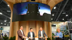 our Volvo executives standing on a stage at ACT Expo beneath a large digital screen displaying the yellow silhouette of a new heavy-duty vocational truck. our Volvo executives standing on a stage at ACT Expo beneath a large digital screen displaying the yellow silhouette of a new heavy-duty vocational truck.