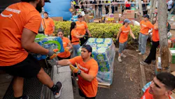 Volunteers from Amazon sort and pack emergency supplies for Venezuela earthquake relief alongside the nonprofit Global Empowerment Mission in Miami, Florida.