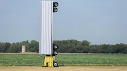 Surreal photo of a commercial semi-truck perched atop a utility pole in an open field, symbolizing a capacity illusio