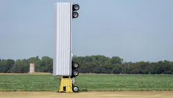 Surreal photo of a commercial semi-truck perched atop a utility pole in an open field, symbolizing a capacity illusio
