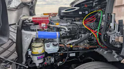 The open hood and engine compartment of a Fifth Generation Freightliner Cascadia revealing the heavy-duty Detroit Gen 6 diesel engine.