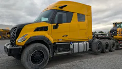 Yellow VNX 640 with lowboy trailer
