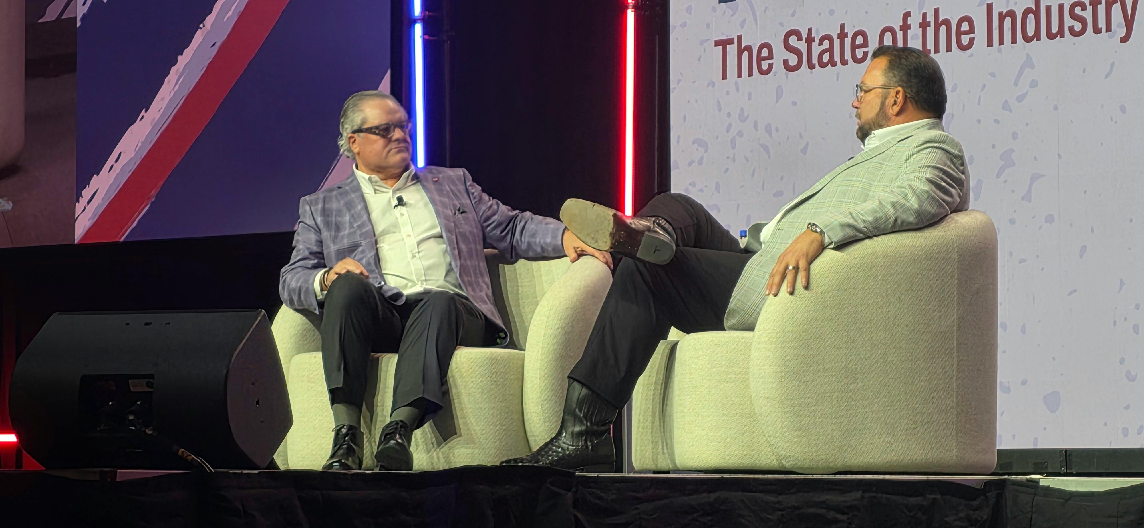 Outgoing ATA Chairman Greg Hodgen, left, and incoming Chairman Derek Leathers discuss recent legislative and regulatory victories from the MCE stage.